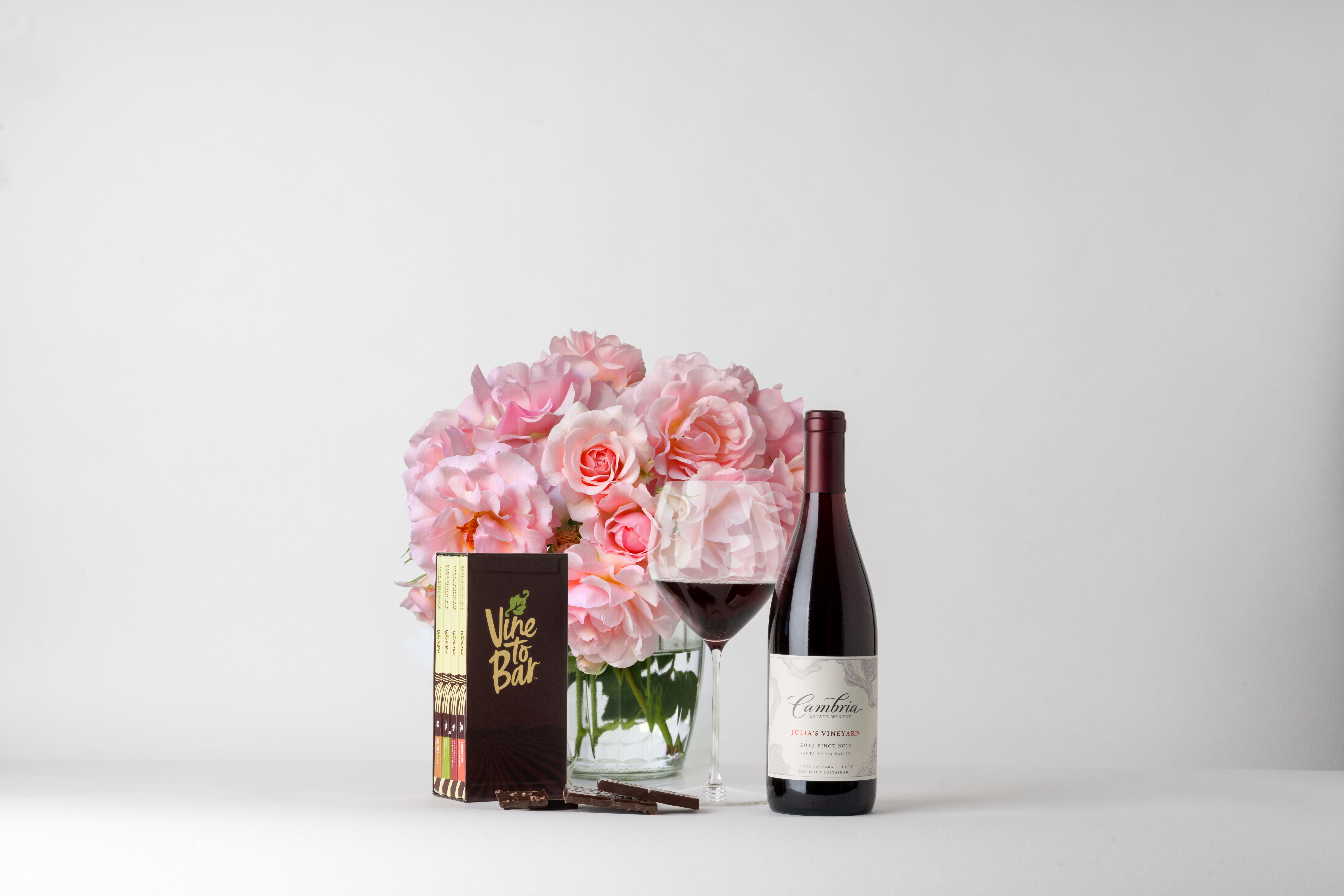 Rose wine and gift box with ribbon and dessert